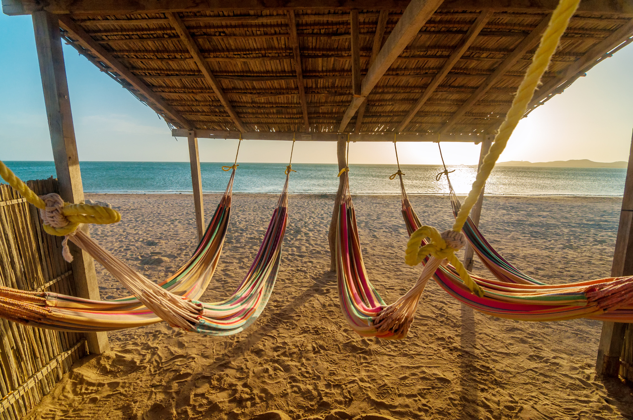 Bright colorful hammocks on the beach at sun